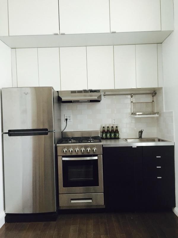 a kitchen with stainless steel appliances a refrigerator and a stove