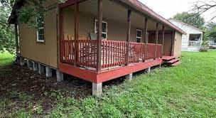 a view of a house with a small yard and wooden fence