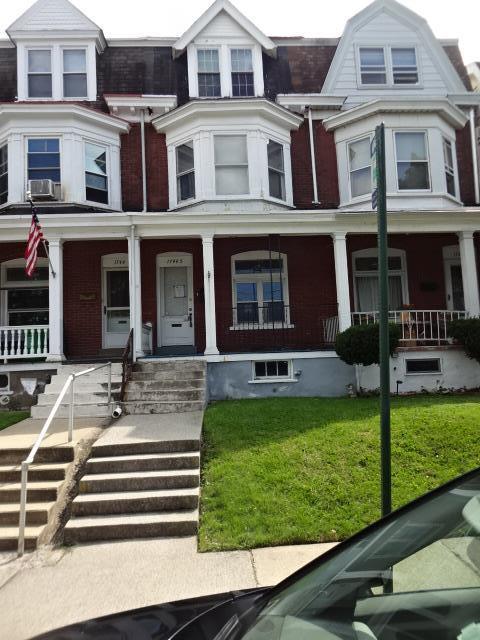 a front view of a residential apartment building with a yard