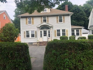 a front view of a house with a garden