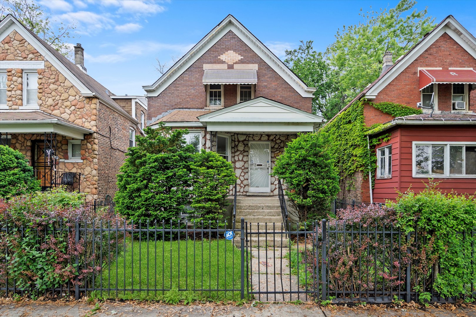 a front view of a house with a garden