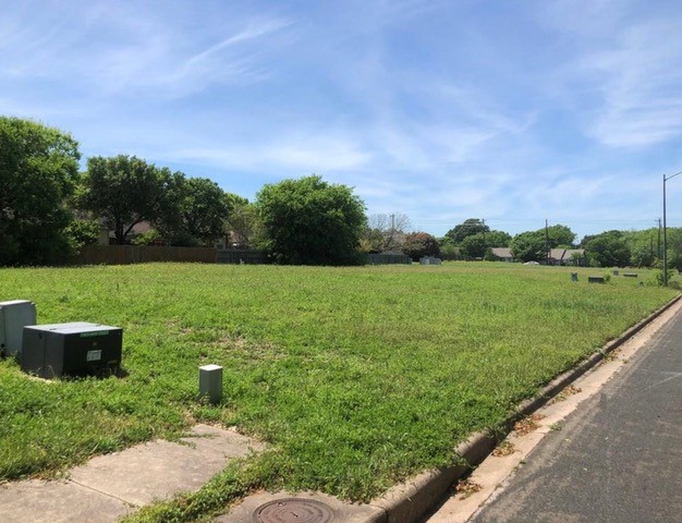 a view of a garden with a building in the background