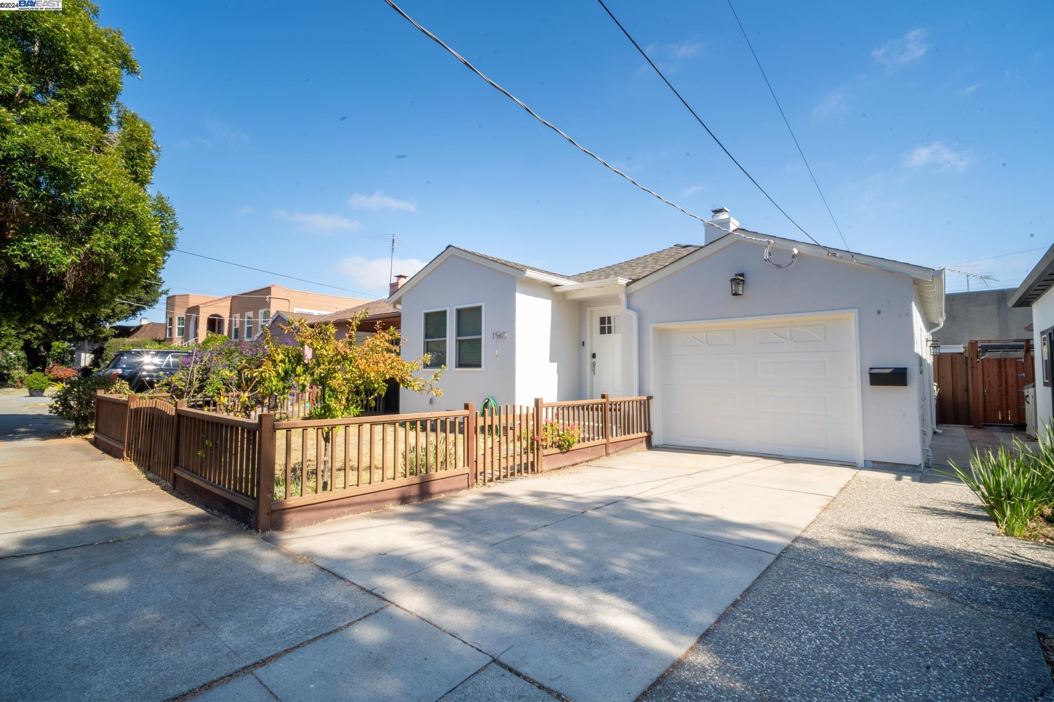 a view of a house with wooden fence