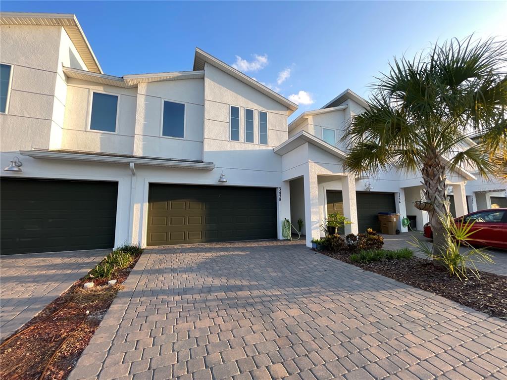 a front view of a house with a yard and garage