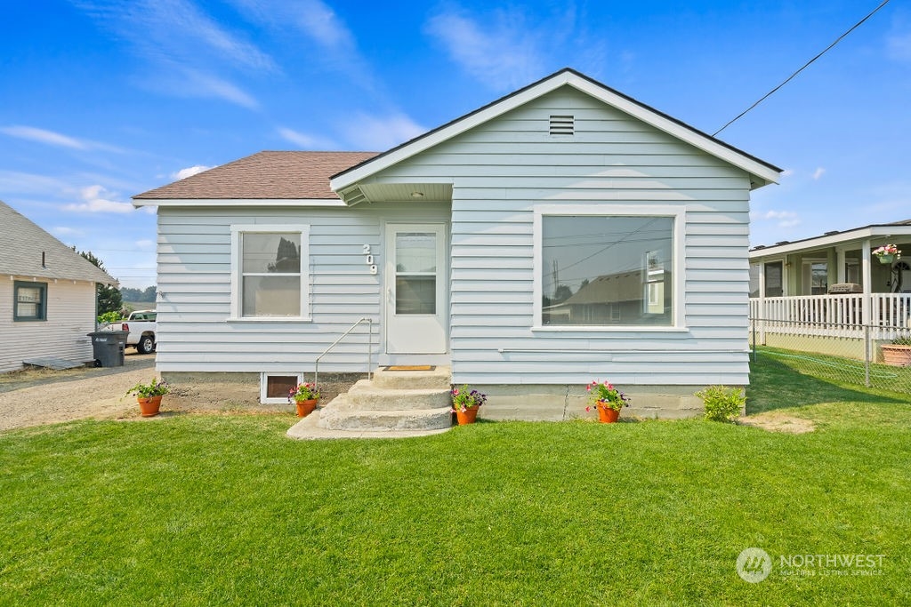 a front view of house with yard and outdoor seating