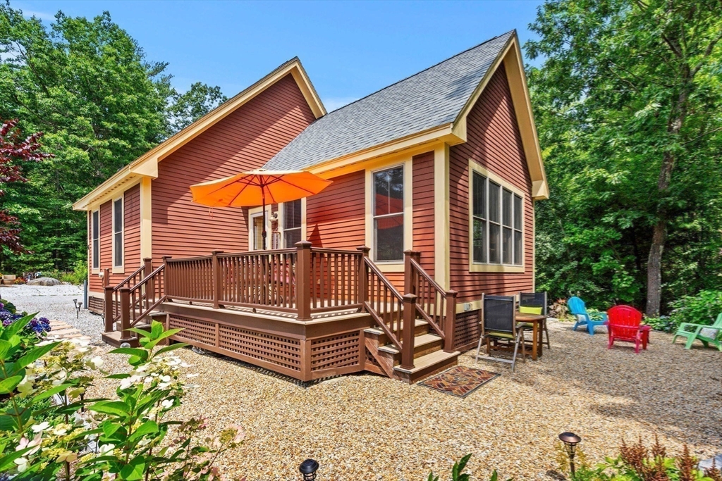 aerial view of a house with a yard and furniture