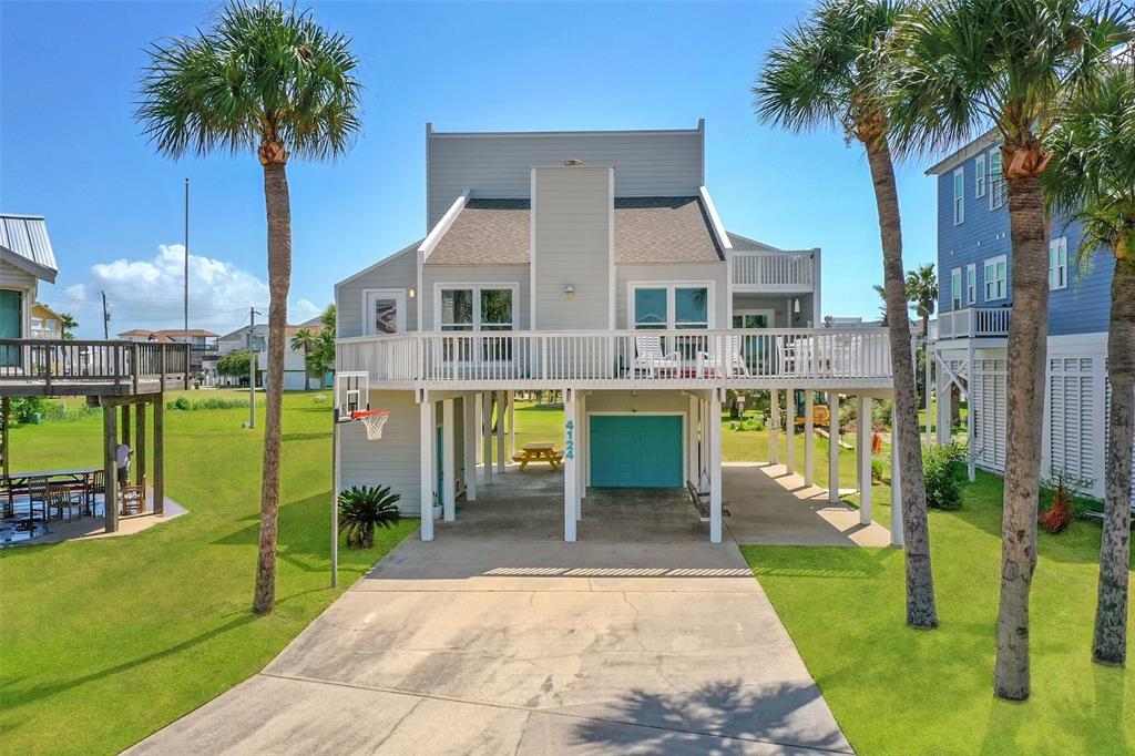 a view of a house with backyard porch and sitting area