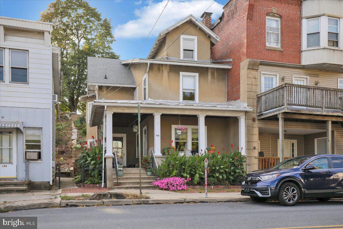 a front view of a house with garden