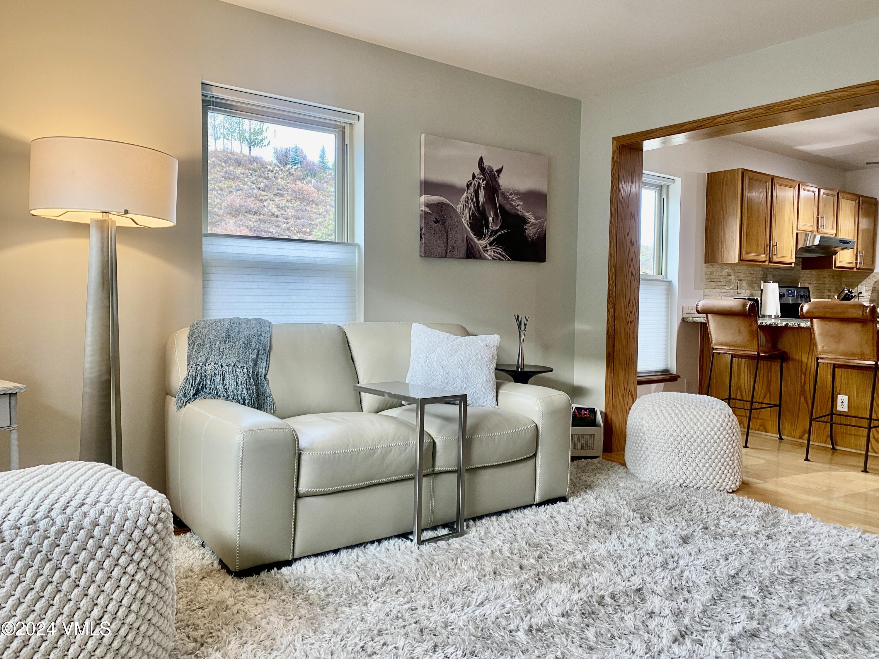 a living room with furniture and a lamp