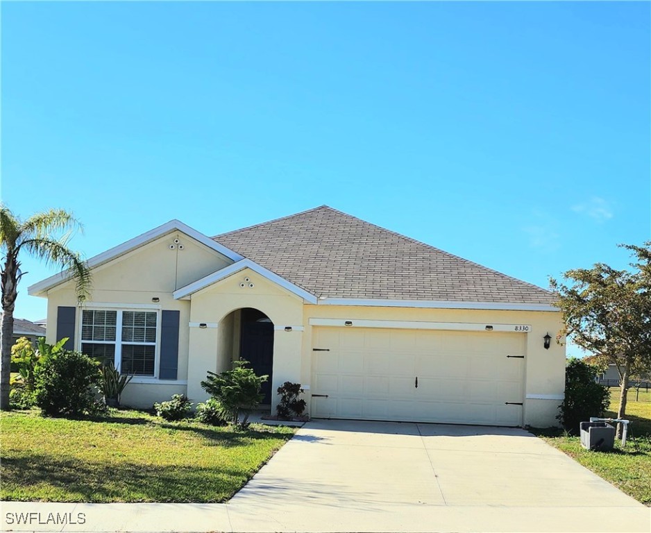 a front view of a house with yard and garage