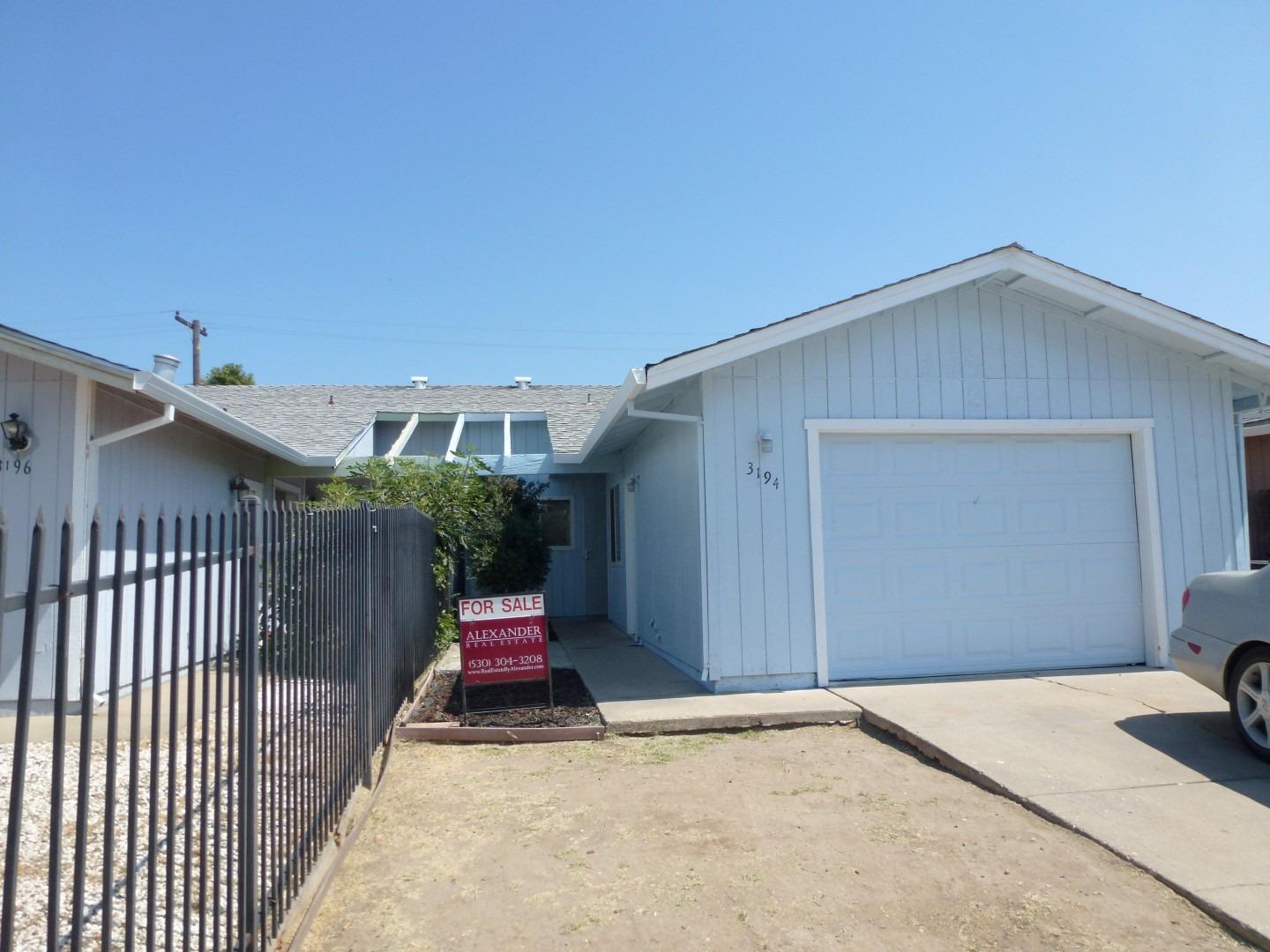 a view of a house with wooden fence