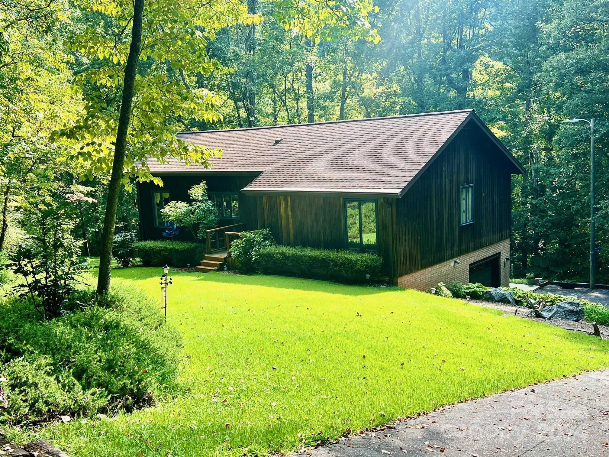 a view of a house with a yard and tree s