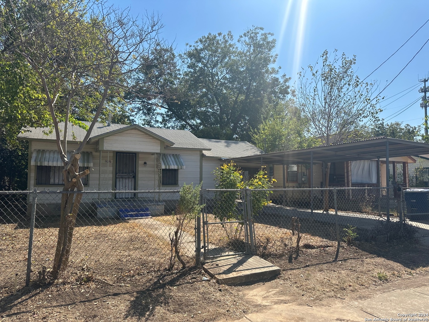 a backyard of a house with barbeque oven table and chairs