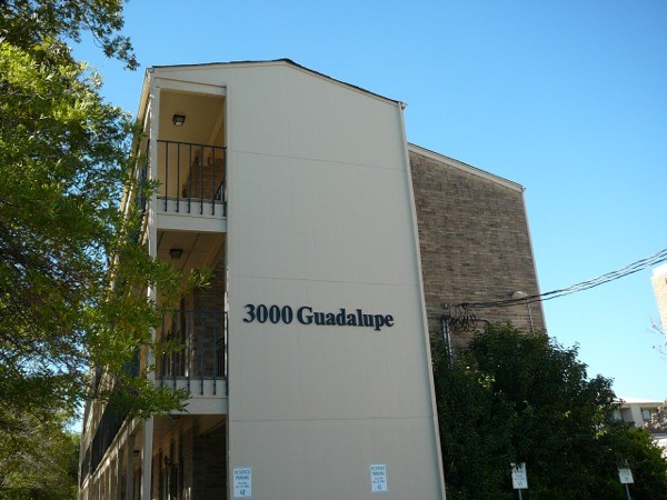 a front view of a house with plants