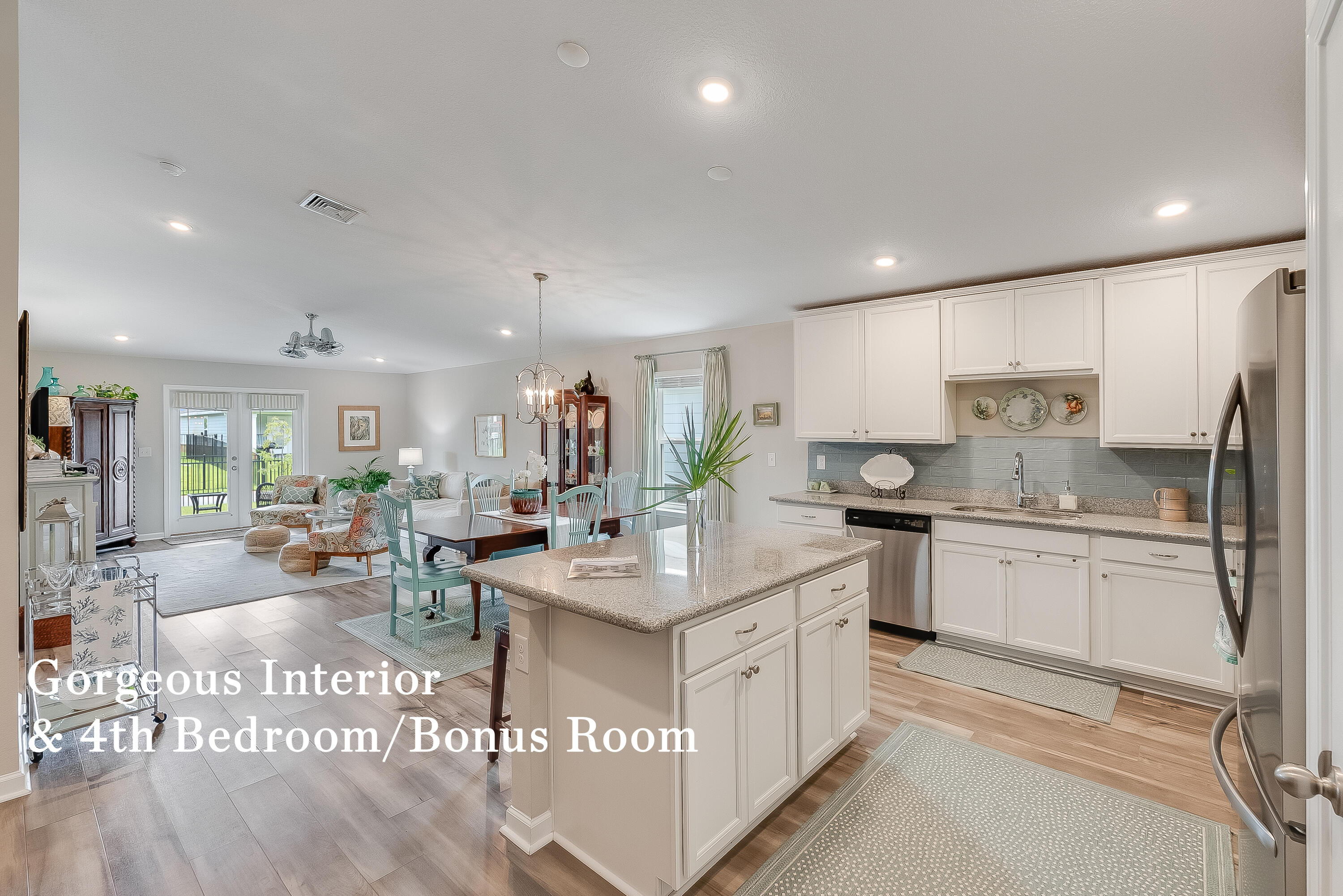 a large kitchen with kitchen island a large counter top stainless steel appliances and cabinets