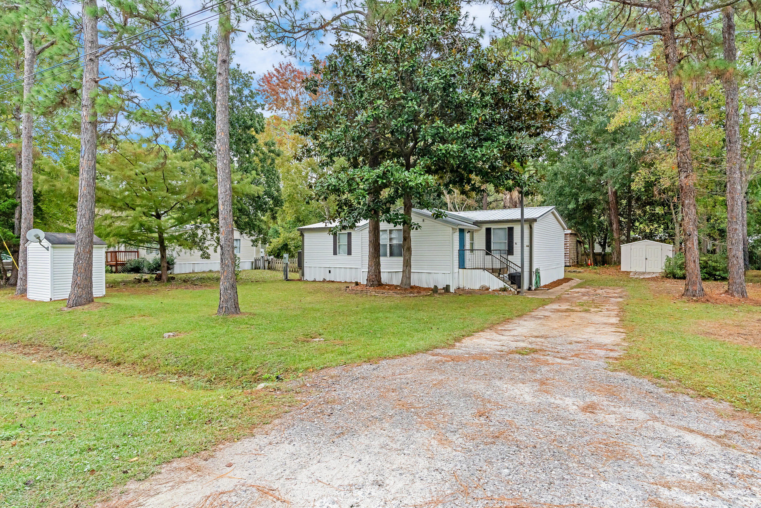 a view of a house with backyard and a tree