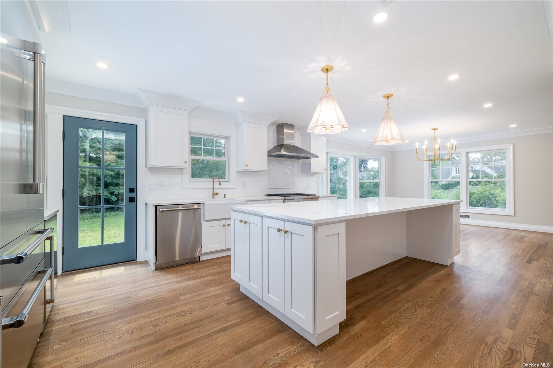 a kitchen with kitchen island granite countertop a sink cabinets and wooden floor