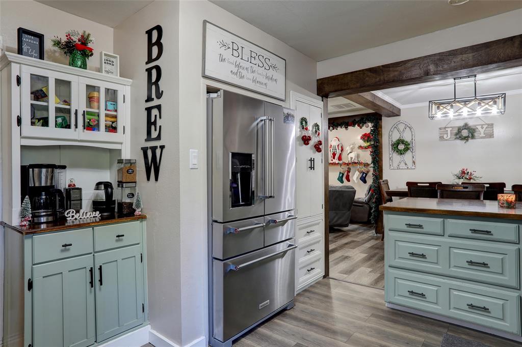 a kitchen with stainless steel appliances kitchen island granite countertop a refrigerator and cabinets