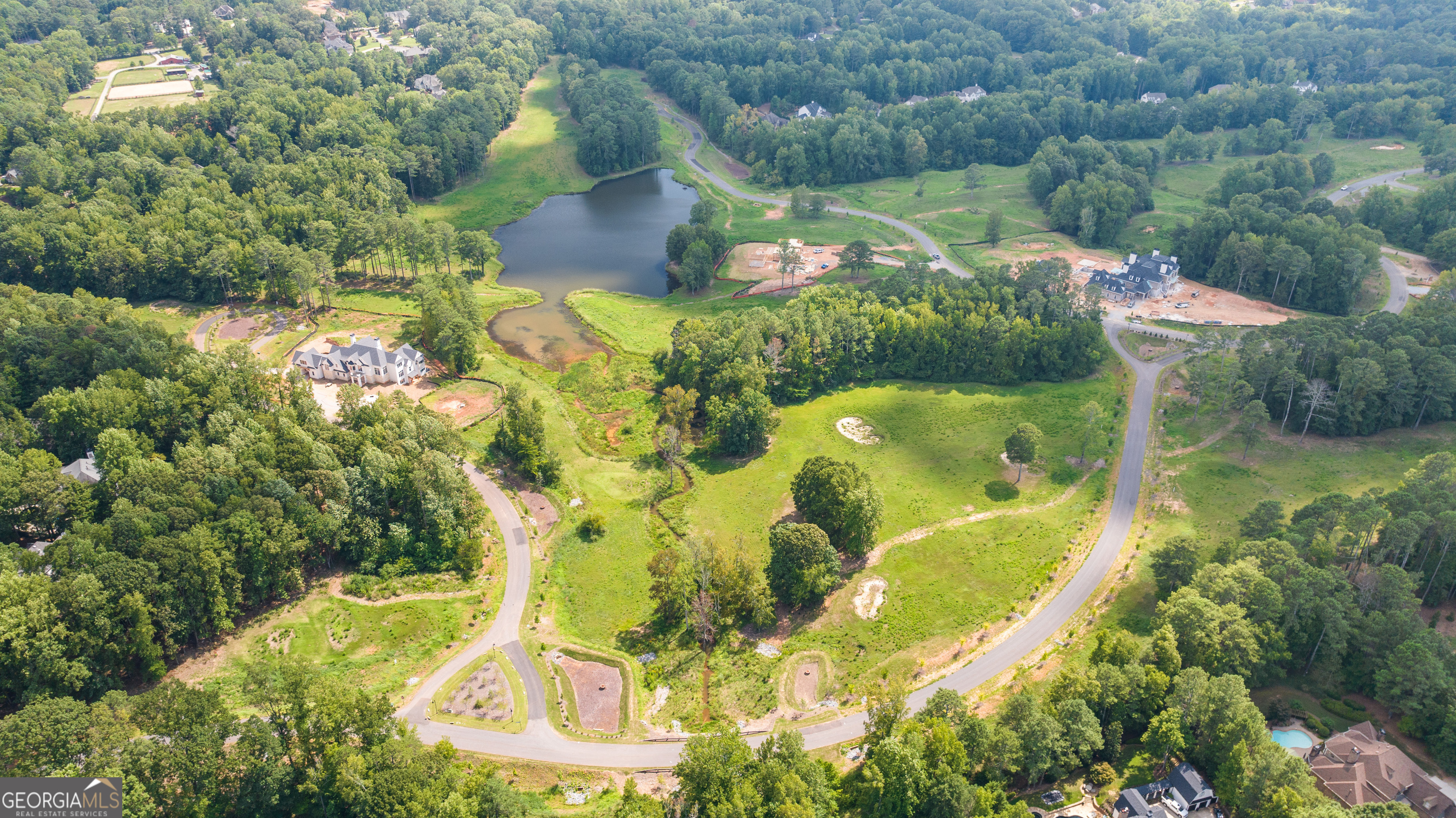 an aerial view of residential house with outdoor space and swimming pool