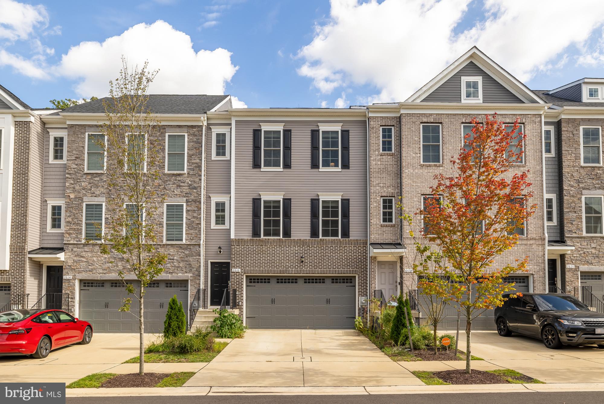 a front view of a residential apartment building with a yard