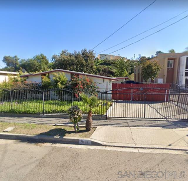 a view of a backyard with wooden fence