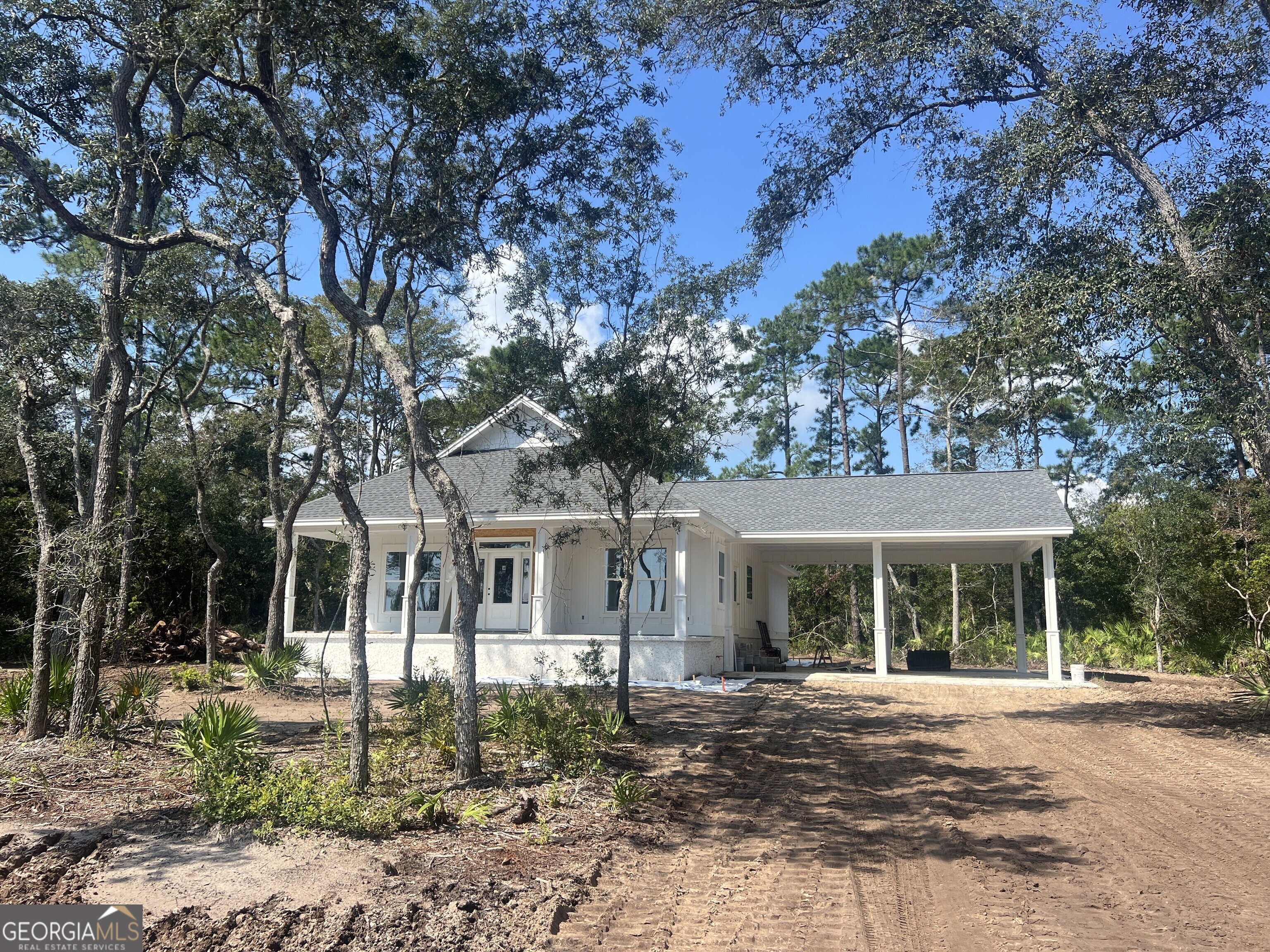 front view of a house with a tree in front of it