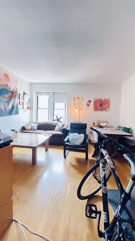 a living room with furniture a rug and a window