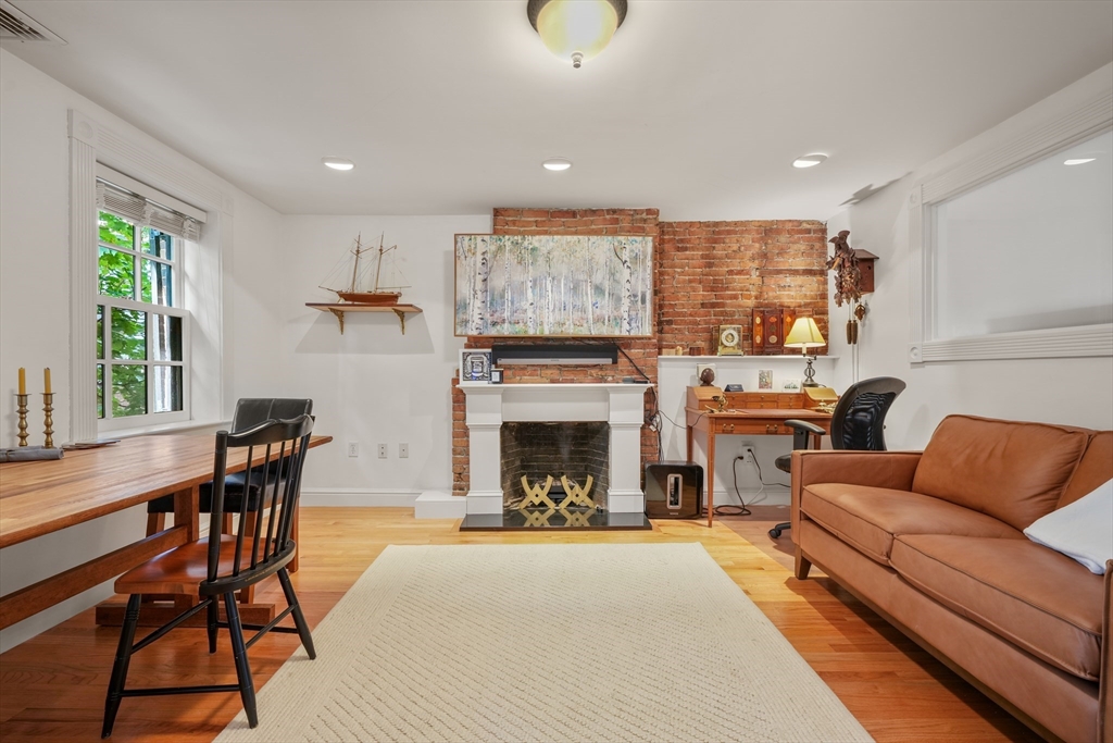 a living room with furniture a fireplace and a large window