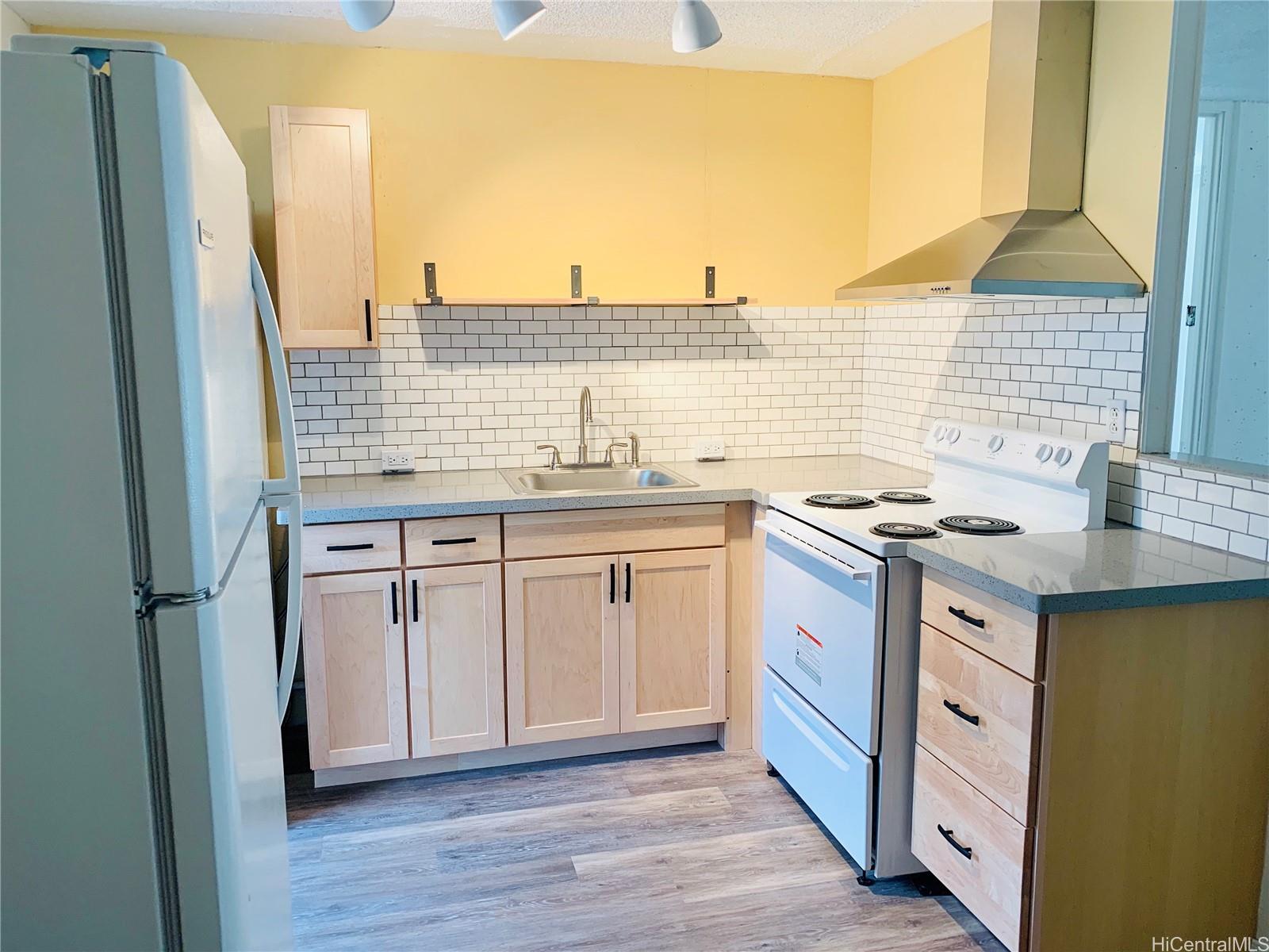 a kitchen with stainless steel appliances granite countertop a sink and cabinets