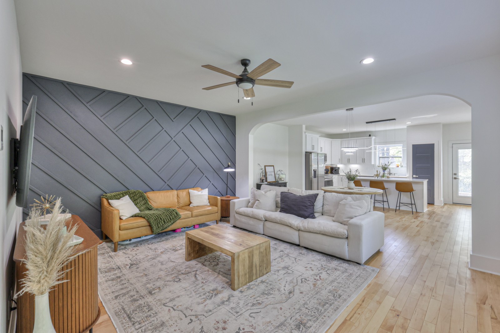 a living room with furniture and wooden floor