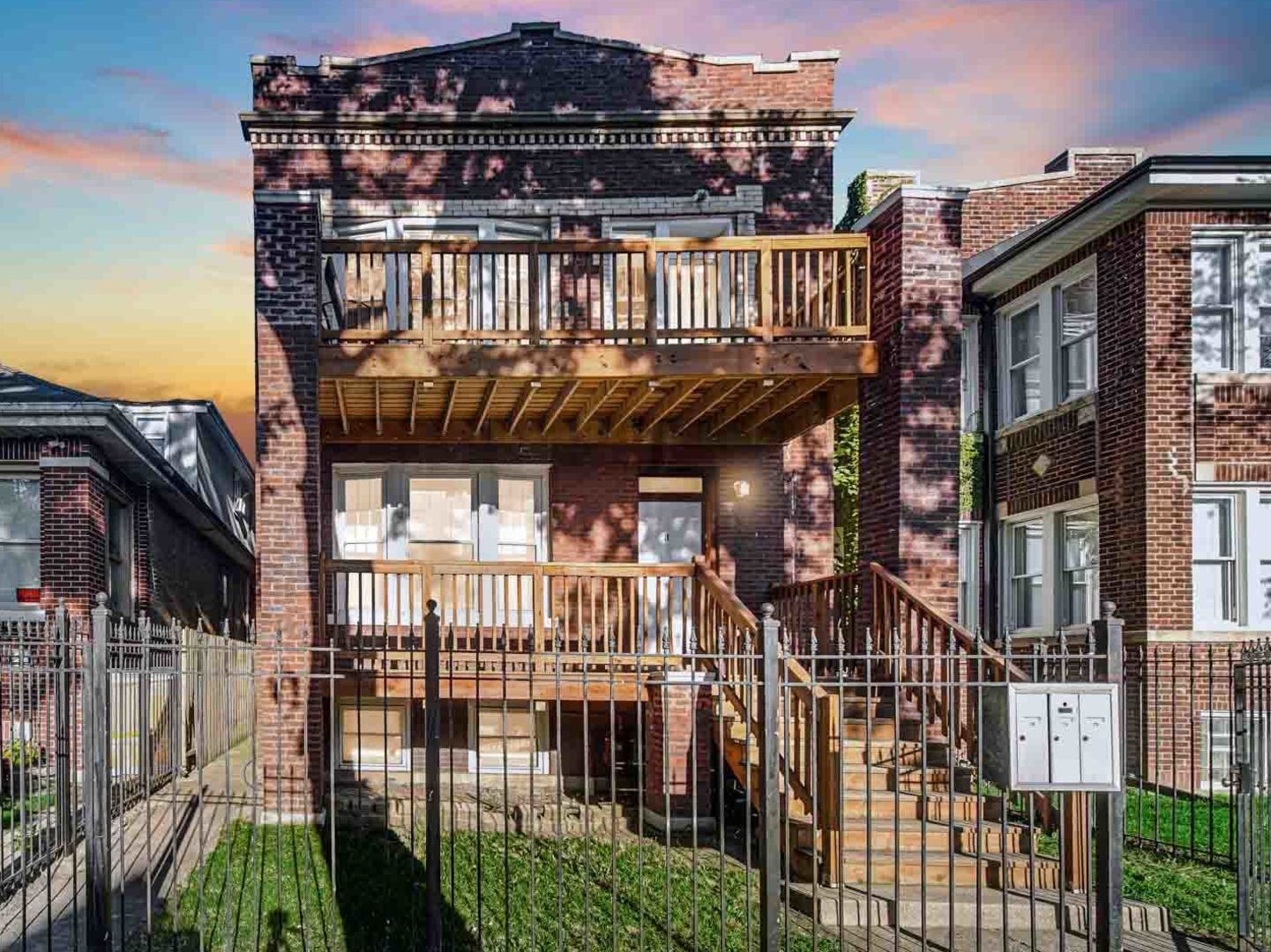 a view of a balcony with iron stairs