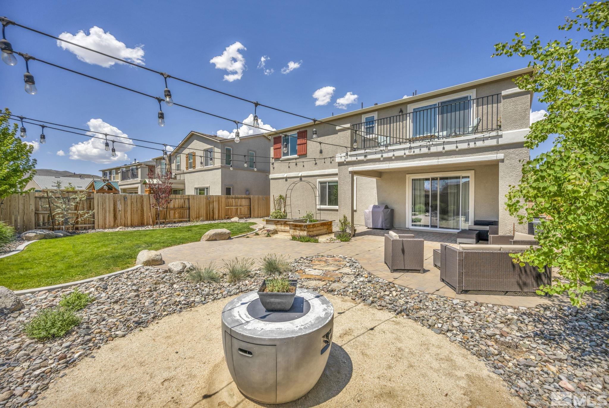 a view of a house with a patio and a yard