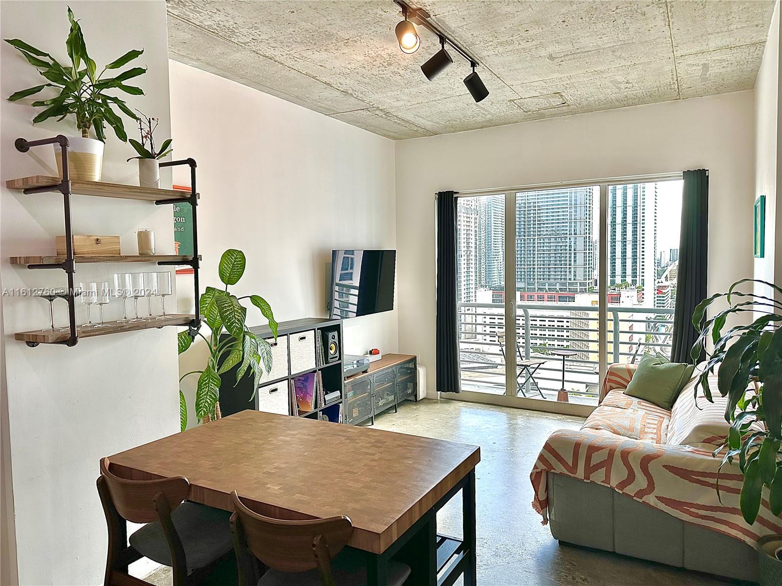 a living room with furniture a large window with wooden floor