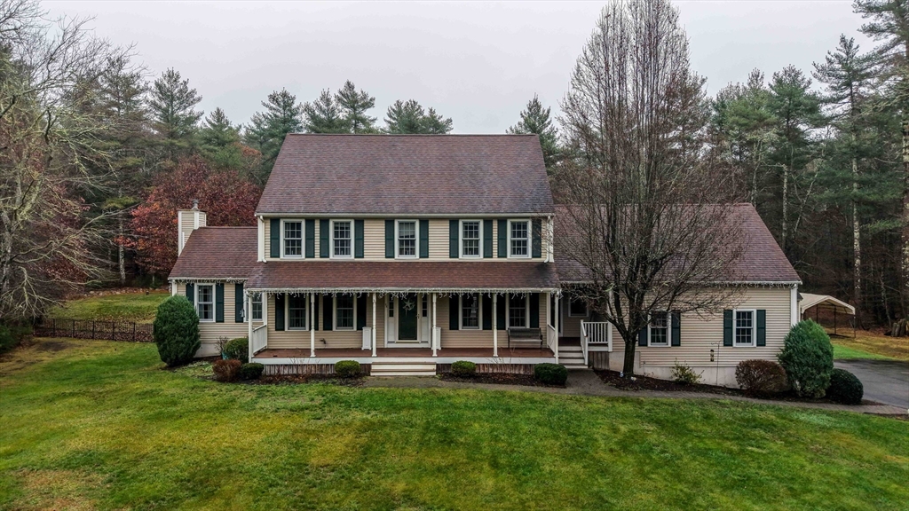 a view of a house with a yard and sitting area