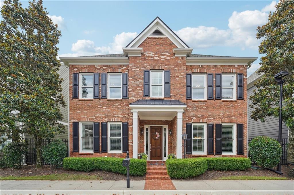 a front view of a brick house with a yard