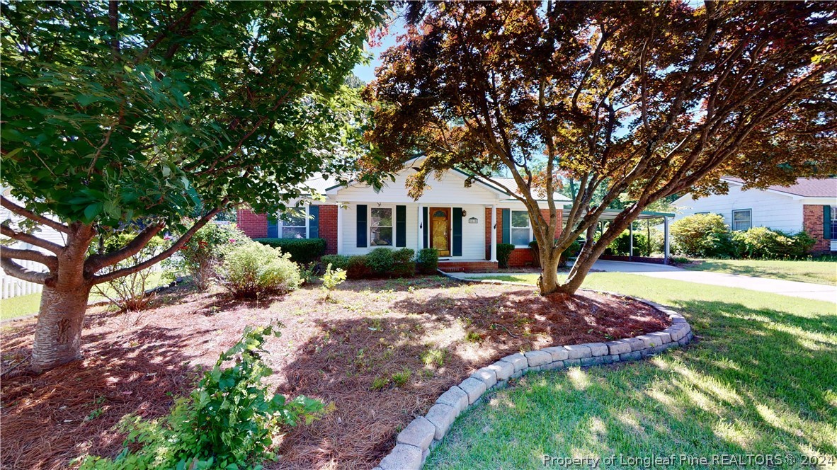 a front view of a house with a garden