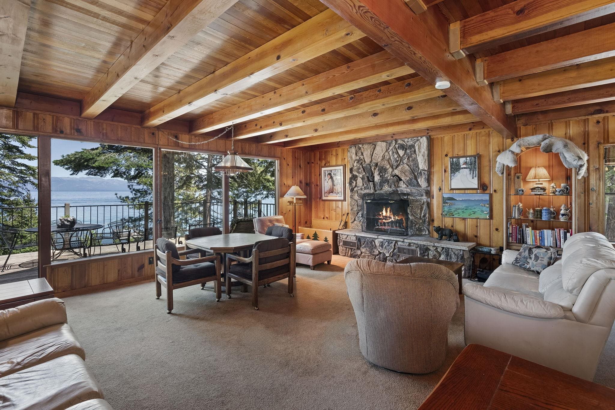 a living room with furniture a fireplace and a large window