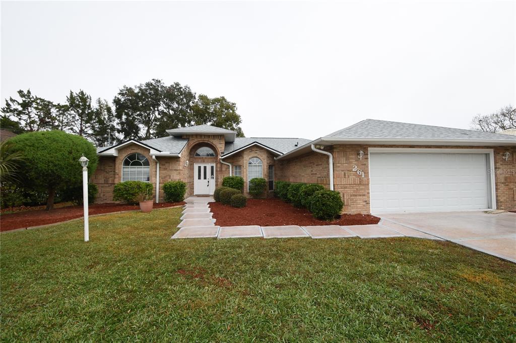 a front view of a house with a yard