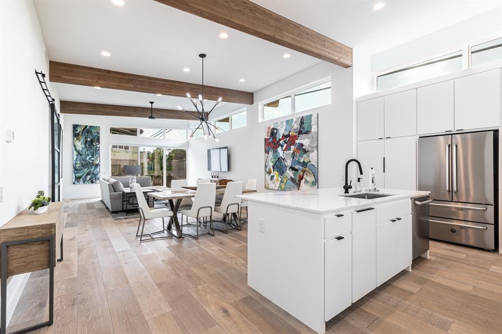 a very nice looking living room with stainless steel appliances furniture a fireplace and a large window