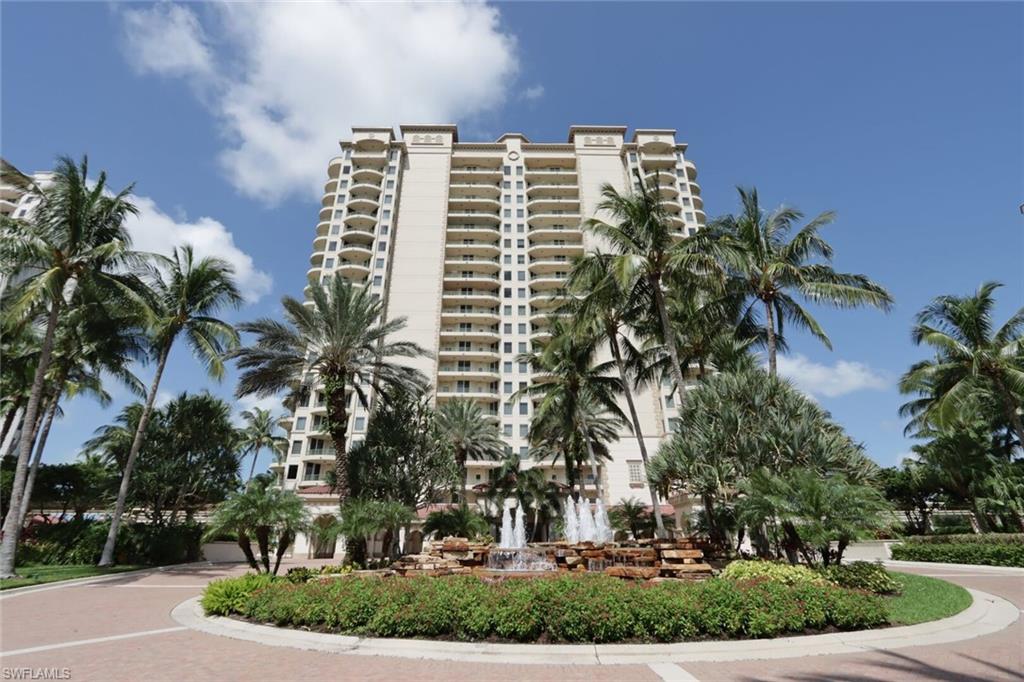 a front view of a multi story building with yard