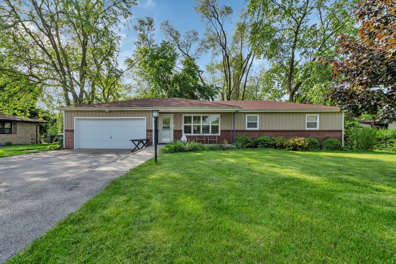 a view of a house with a yard and tree s