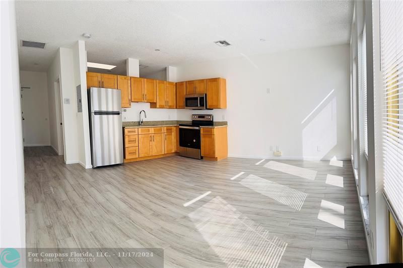 a kitchen with granite countertop a stove and a refrigerator