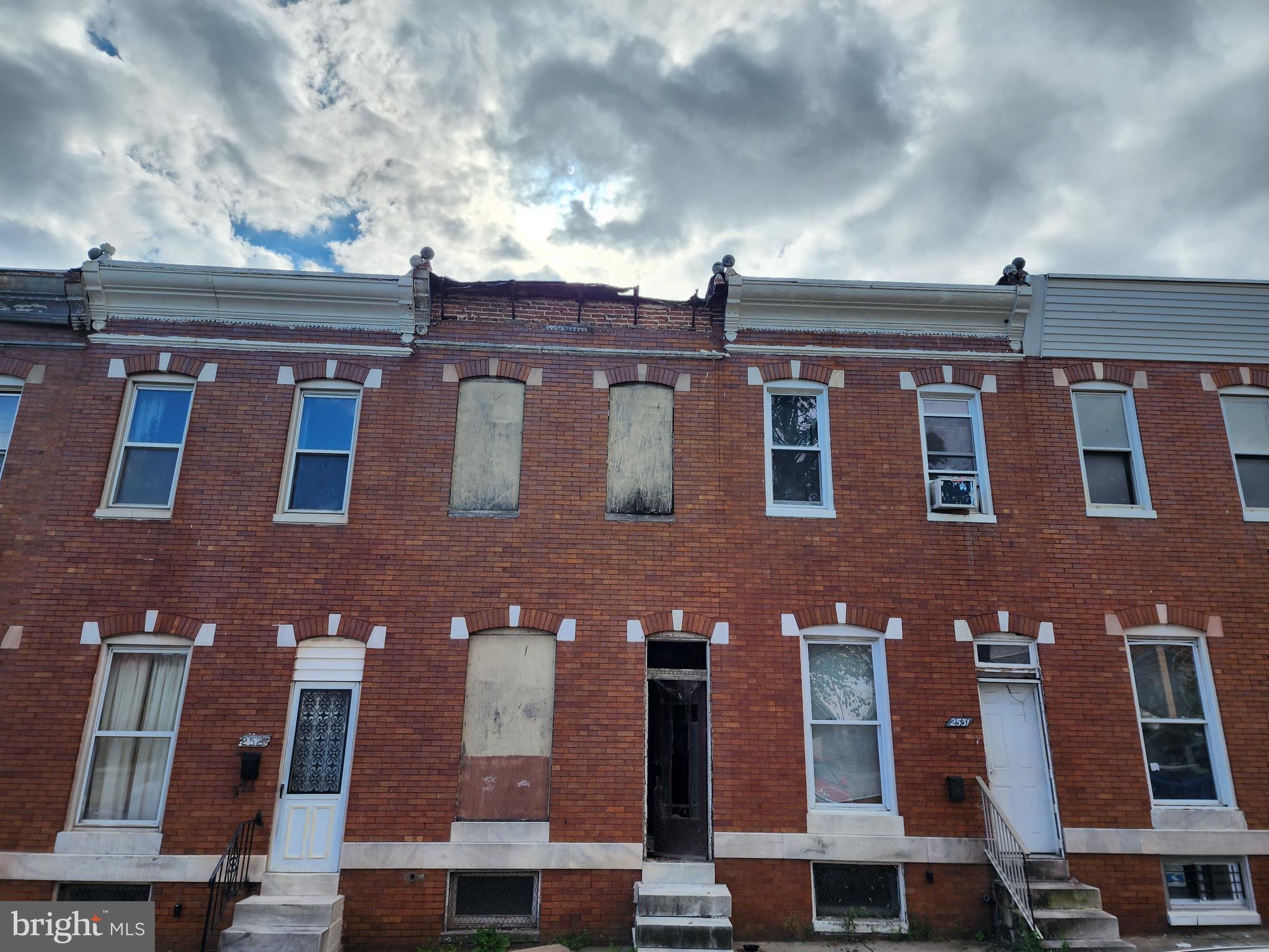 a front view of residential houses with glass windows