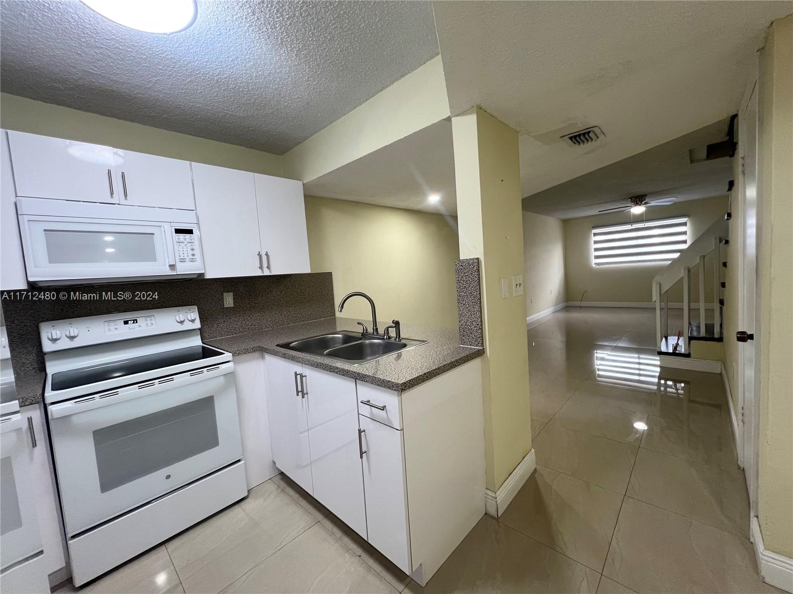 a kitchen with stainless steel appliances granite countertop a stove and a sink