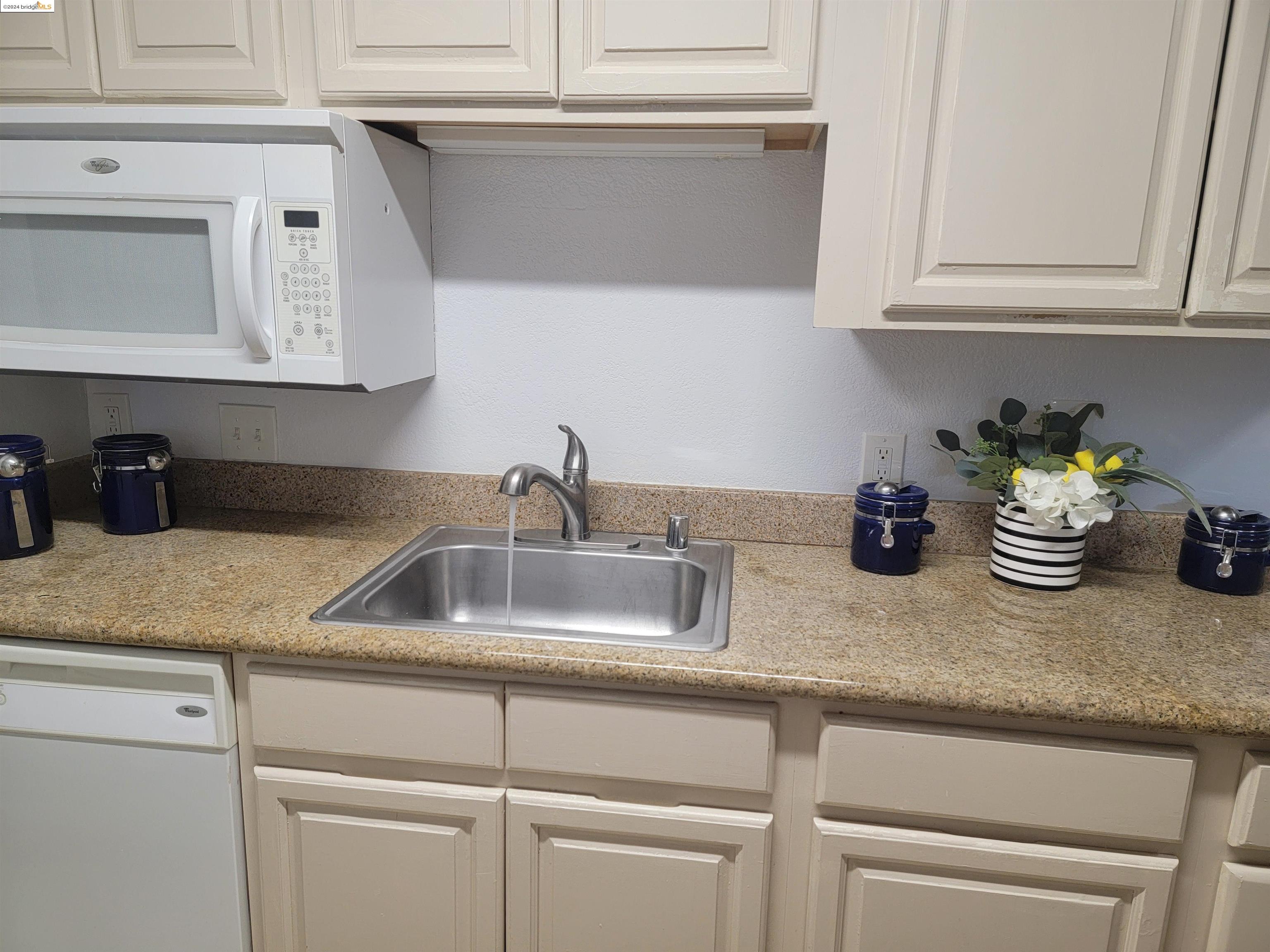 a kitchen with kitchen island a sink and cabinets