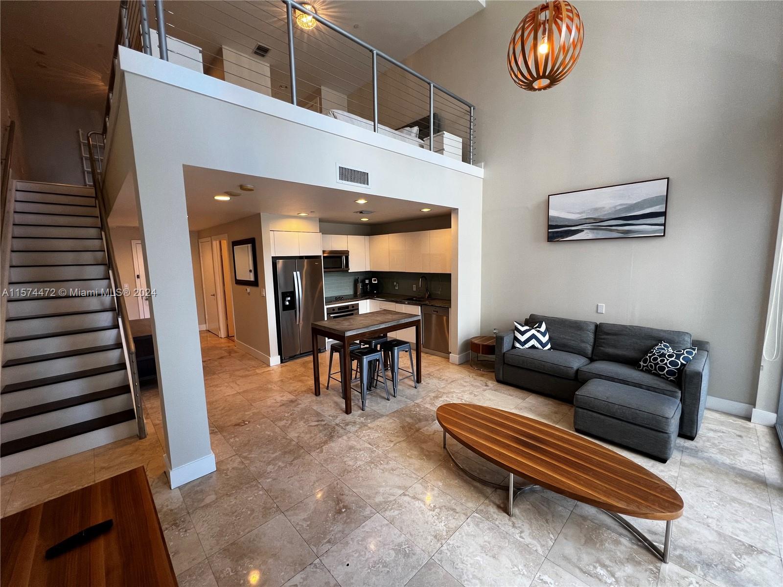 a living room with furniture and a piano