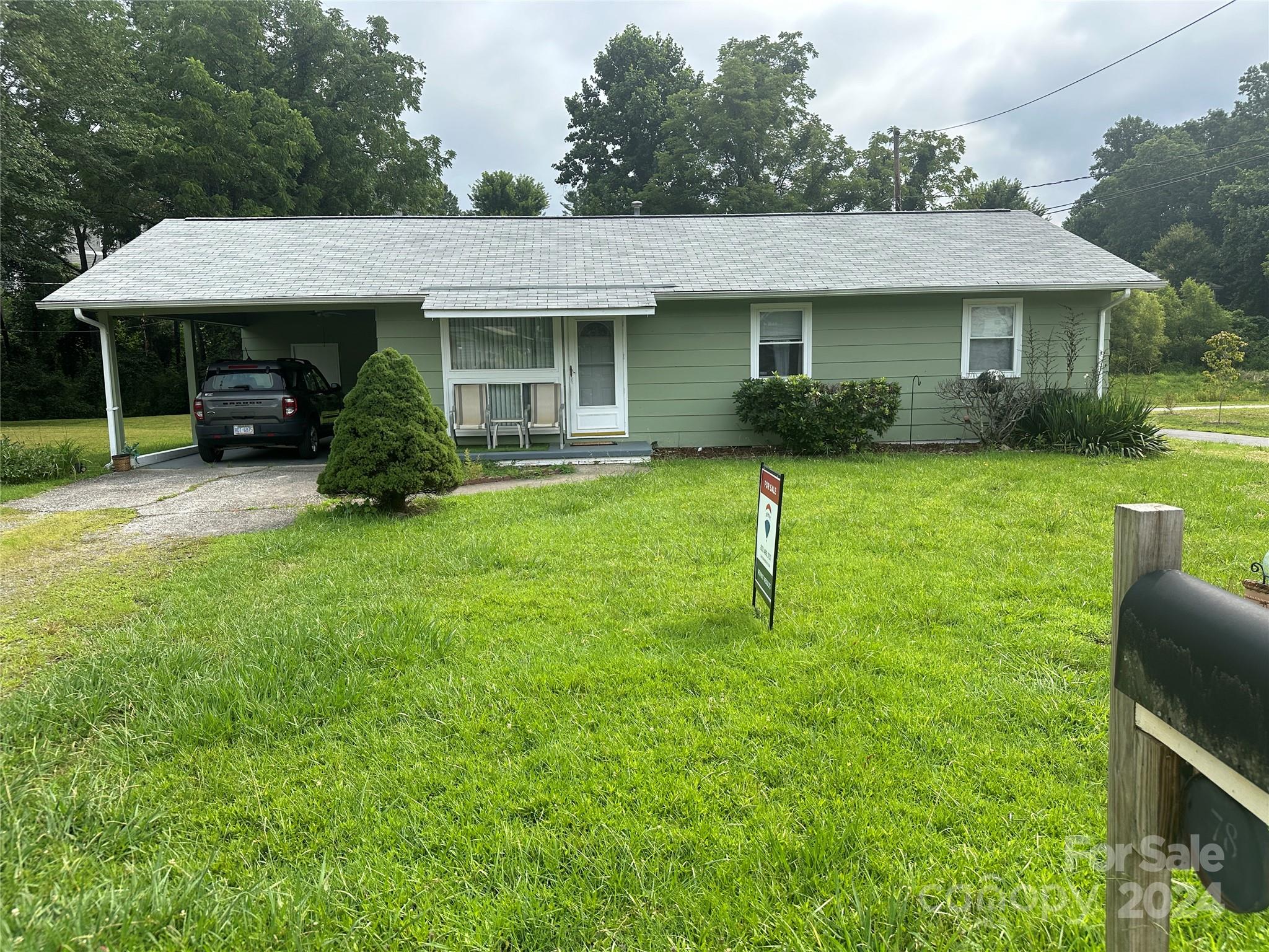 a front view of a house with a garden