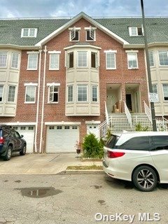 a front view of a house with parking space