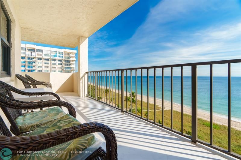 a view of a balcony with chair and wooden floor