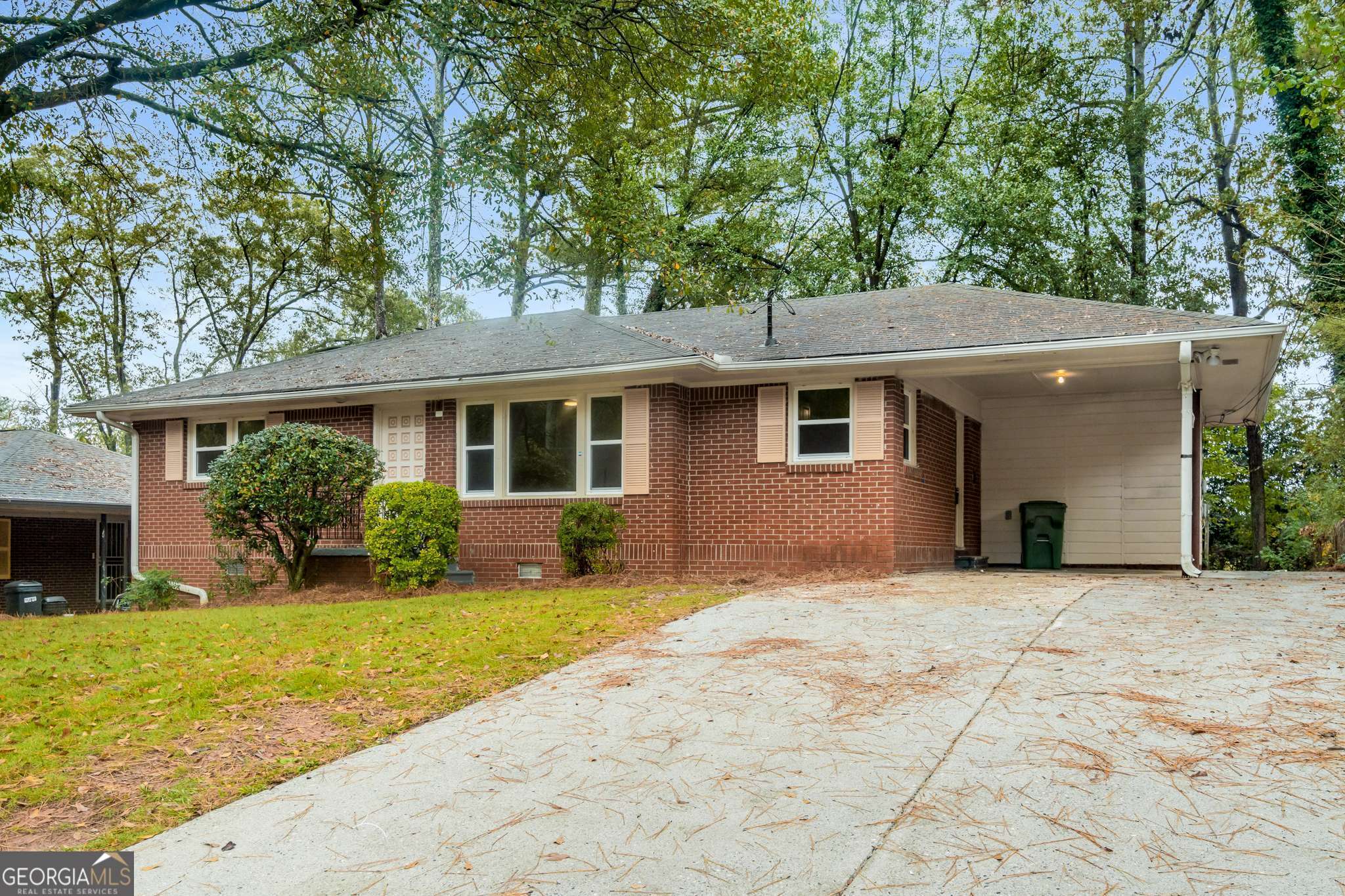 a front view of a house with yard and green space